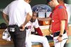 Boston Red Sox relief pitcher Aroldis Chapman, center, is patted on the shoulder by pitching coach Andrew Bailey, right, in the dugout after he left a baseball game with an apparent injury in the eighth inning against the Los Angeles Dodgers, Sunday, July 27, 2025, in Boston. (AP Photo/Jim Davis)