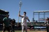 Seattle Mariners' Dominic Canzone, center, holds a trident and celebrates after hitting an RBI walkoff single in the 11th inning of a baseball game against the Chicago White Sox, Thursday, Aug. 7, 2025, in Seattle. (AP Photo/Jason Redmond)