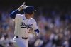 Los Angeles Dodgers' Freddie Freeman celebrates after hitting a walk-off single during the ninth inning of a baseball game against the Minnesota Twins, Wednesday, July 23, 2025, in Los Angeles. (AP Photo/Mark J. Terrill)