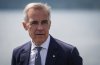 Prime Minister Mark Carney listens while touring the Royal Canadian Navy torpedo recovery vessel Sikanni at the Canadian Forces Maritime Experimental and Test Ranges (CFMETR), in Nanoose Bay, B.C.,, on Monday, August 4, 2025. THE CANADIAN PRESS/Darryl Dyck