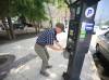 Ruth Bonneville / Free Press
                                A City of Winnipeg worker removes the cash box at a parking pay station before the pay stations are permanently removed Tuesday. Drivers wanting to park on city streets will now have to use a phone app to pay for their parking.