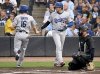 Los Angeles Dodgers' Will Smith (16) and Shohei Ohtani (17) score on a double by Freddie Freeman (not pictured) during the first inning of a baseball game against the Tampa Bay Rays Friday, Aug. 1, 2025, in Tampa, Fla. (AP Photo/Jason Behnken)