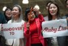 Billionaire Ruby Liu, centre, poses with her staff while holding a set of keys to a former Hudson's Bay-owned Saks Off 5th department store during a 