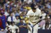 Milwaukee Brewers' Christian Yelich (22) watches his two-run home run against the Chicago Cubs during the seventh inning of a baseball game, Monday, July 28, 2025, in Milwaukee. (AP Photo/Jeffrey Phelps)