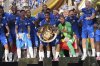President Donald Trump, back from fourth from right, stands on stage after presenting the championship trophy to Chelsea following the Club World Cup final soccer match between Chelsea and PSG at MetLife Stadium in East Rutherford, N.J., Sunday, July 13, 2025. (AP Photo/Jacquelyn Martin)