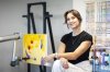 Acrylic Robotics founder Chloë Ryan poses for a photograph with an in-progress copy of Norval Morrisseau's 