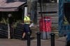 A Canada Post employee prepares to check a street letter box while delivering mail, in White Rock, B.C., on Monday, July 28, 2025. Unionized workers at Canada Post rejected the Crown corporatin's latest offers in a forced ratification vote. THE CANADIAN PRESS/Darryl Dyck