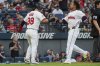 Cleveland Guardians' Steven Kwan (38) congratulates Jose Ramirez, right, after they scored on a single by Kyle Manzardo during the fourth inning of a baseball game against the Baltimore Orioles, Wednesday, July 23, 2025, in Cleveland. (AP Photo/Phil Long)