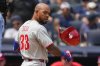 Philadelphia Phillies' Edmundo Sosa (33) throws a helmet after striking out during the fifth inning of a baseball game against the New York Yankees, Saturday, July 26, 2025, in New York. (AP Photo/Yuki Iwamura)