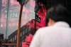 A person stands in front of an electronic stock board showing Japan's Nikkei index at a securities firm Tuesday, Aug. 12, 2025, in Tokyo. (AP Photo/Eugene Hoshiko)