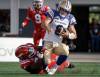 Winnipeg Blue Bombers quarterback Zach Collaros, right, is sacked by Calgary Stampeders&rsquo; Jaylon Hutchings during second half CFL football action in Calgary, Alta., Saturday, Aug. 9, 2025. THE CANADIAN PRESS/Jeff McIntosh