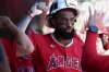Los Angeles Angels outfielder Jo Adell celebrates in the dugout after hitting a three-run home run during the first inning of a baseball game against the Athletics, Sunday, Aug. 17, 2025, in West Sacramento, Calif. (AP Photo/Sara Nevis)