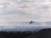 A water bomber flies over a wildfire in the Paddy's Pond area just outside St. John's, N.L., on Wednesday, Aug. 13, 2025. THE CANADIAN PRESS/Elling Lien