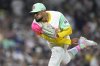 San Diego Padres relief pitcher Robert Suarez works against a Los Angeles Dodgers batter during the ninth inning of a baseball game Friday, Aug. 22, 2025, in San Diego. (AP Photo/Orlando Ramirez)