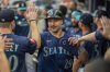 Seattle Mariners catcher Cal Raleigh (29) celebrates after scoring the first run during the first inning of a baseball game against the Atlanta Braves Saturday, Sept. 6, 2025, in Atlanta. (AP Photo/Erik Rank)