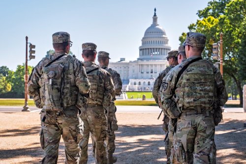 Armed National Guard soldiers from West Virginia patrol the Mall near the Capitol in Washington, as part of President Donald Trump's order to impose federal law enforcement in the District of Columbia, Tuesday, Aug. 26, 2025. (AP Photo/J. Scott Applewhite)