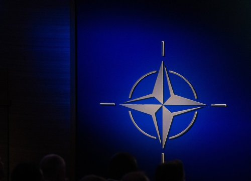 The NATO logo is illuminated beside the stage during a ceremony celebrating NATO's 75th anniversary in Washington on Tuesday, July 9, 2024. THE CANADIAN PRESS/Adrian Wyld