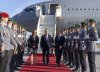 Prime Minister Mark Carney, centre, is met by a welcoming committee as he disembarks the government plane in Berlin, Germany on Monday, Aug. 25, 2025. THE CANADIAN PRESS/Christinne Muschi