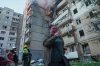 A woman reacts in front of a residential building heavily damaged by a Russian strike in Kyiv, Ukraine, on Sunday, Sept. 7, 2025. (AP Photo/Evgeniy Maloletka)