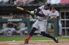 Cleveland Guardians' Carlos Santana hits a two-run double during the first inning of a baseball game against the Chicago White Sox, Friday, Aug. 8, 2025, in Chicago. (AP Photo/Erin Hooley)