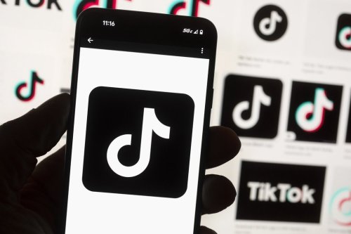 FILE - The TikTok logo is seen on a mobile phone in front of a computer screen which displays the TikTok home screen, Oct. 14, 2022, in Boston. (AP Photo/Michael Dwyer, File)