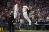 Philadelphia Phillies' J.T. Realmuto, right, and Bryce Harper celebrate after Realmuto's two-run home run against Seattle Mariners pitcher Matt Brash during the eighth inning of a baseball game Tuesday, Aug. 19, 2025, in Philadelphia. (AP Photo/Matt Slocum)