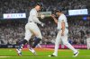 New York Yankees' Aaron Judge celebrates with third base coach Luis Rojas after hitting a three-run home run against the Toronto Blue Jays during the fourth inning of Game 3 of baseball's American League Division Series, Tuesday, Oct. 7, 2025, in New York. (AP Photo/Yuki Iwamura)
