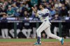 Seattle Mariners' Jorge Polanco watches the ball after hitting a solo home run during the sixth inning in Game 2 of baseball's American League Division Series against the Detroit Tigers, Sunday, Oct. 5, 2025, in Seattle. (AP Photo/John Froschauer)