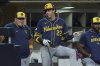 Milwaukee Brewers' Christian Yelich (22) talks with manager Pat Murphy in the dugout during the fourth inning of a baseball game against the San Diego Padres Monday, Sept. 22, 2025, in San Diego. (AP Photo/Gregory Bull)