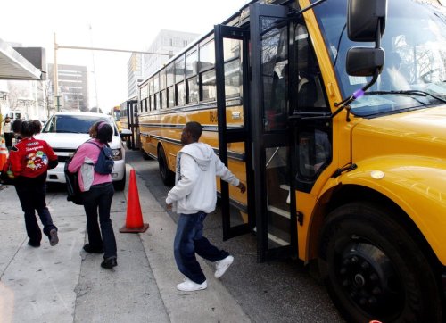FILE - Kids from Ossie Wera Mitchell Middle School exit the bus in Birmingham, Ala. on Jan 20, 2009. (AP Photo/Butch Dill, File)