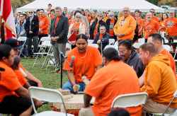 People attend a ceremony to unveil educational plaques at the memorial site at the Assiniboia Residential School Tuesday.