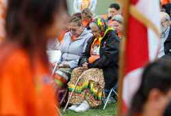 People attend a ceremony to unveil educational plaques at the memorial site at the Assiniboia Residential School Tuesday.