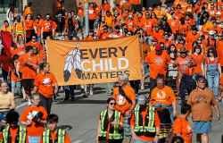 People take part in the Orange Shirt Healing Walk and Powwow in Winnipeg Tuesday.