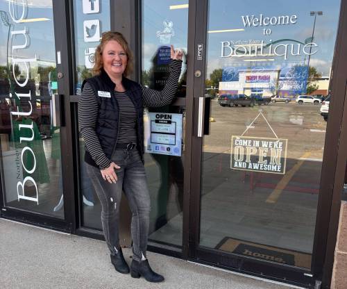 Kay Rone, who owns Northern Roots Boutique in Grand Forks, N.D., for years has displayed a sign in her window that welcomes Canadian shoppers. (Supplied)