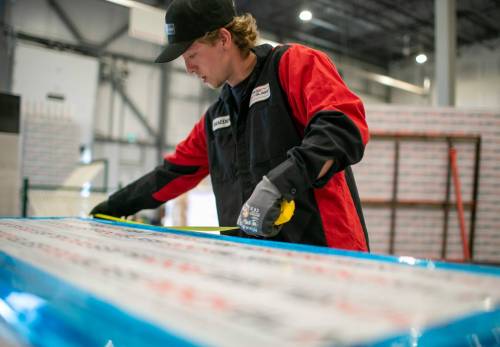 photos by BROOK JONES / FREE PRESS 
                                ClearSecure Manufacturing & Distribution fabricator Braeden Hay measures a panel of RockGlass while working at the company&rsquo;s headquarters at CentrePort Canada (8-3149 Red Fife Rd.) in the RM of Rosser.
