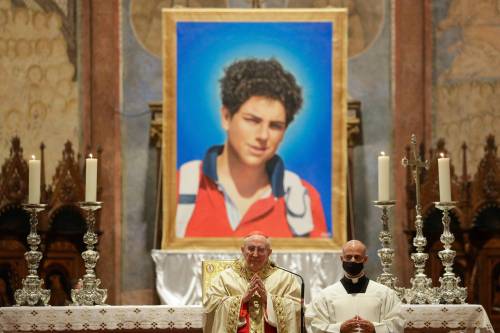 FILE - An image of 15-year-old Carlo Acutis, an Italian boy who died in 2006 of leukemia, is seen during his beatification ceremony celebrated by Cardinal Agostino Vallini, center, in the St. Francis Basilica, in Assisi, Italy, on Oct. 10, 2020. Pope Francis has paved the way for the canonization of the first saint of the millennial generation on Thursday, attributing a second miracle to a 15-year-old Italian computer whiz who died of leukemia in 2006. Carlo Acutis, born on May 3, 1991, in London and then moved with his Italian parents to Milan as a child, was the youngest contemporary person to be beatified by Francis in Assisi in 2020. (AP Photo/Gregorio Borgia, File)