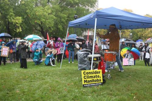NICOLE BUFFIE / FREE PRESS 
Clayton Thomas-Müller, a local activist, spoke in front of nearly 300 climate protesters in the rain Saturday afternoon.