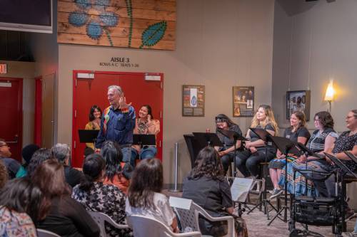 Supplied
                                Ian Ross (standing) introduces Martha Troian&rsquo;s reading of her new work, The Creatives.