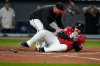 Cleveland Guardians manager Stephen Vogt, left, attends to David Fry after Fry was hit in the face with his own bunt in the sixth inning of a baseball game against the Detroit Tigers in Cleveland, Tuesday, Sept. 23, 2025. (AP Photo/Sue Ogrocki)