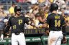 Pittsburgh Pirates' Joey Bart, right, is greeted by Bryan Reynolds, left, after scoring during the fourth inning of a baseball game against the Athletics, Sunday, Sept. 21, 2025, in Pittsburgh. (AP Photo/Matt Freed)