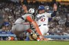 Los Angeles Dodgers' Ben Rortvedt scores on a fielder's choice hit by Mookie Betts as San Francisco Giants catcher Patrick Bailey missed the ball during the sixth inning of a baseball game Thursday, Sept. 18, 2025, in Los Angeles. (AP Photo/Mark J. Terrill)