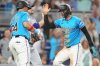 Miami Marlins' Connor Norby, right, is met by Heriberto Hernandez (64) after scoring on a double hit by Eric Wagaman during the fourth inning of a baseball game against the New York Mets1, Sunday, Sept. 28, 2025, in Miami. (AP Photo/Lynne Sladky)