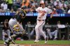 Baltimore Orioles' Jackson Holliday (7) scores past Pittsburgh Pirates catcher Joey Bart, left, on an RBI single hit by Dylan Beavers during the seventh inning of a baseball game, Thursday, Sept. 11, 2025, in Baltimore. (AP Photo/Stephanie Scarbrough)