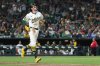 Athletics' Jacob Wilson takes first base after getting hit by a pitch from Kansas City Royals pitcher Carlos Estévez, not shown, during the ninth inning of a baseball game Saturday, Sept. 27, 2025, in West Sacramento, Calif. (AP Photo/Sara Nevis)