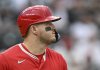 Los Angeles Angels designated hitter Mike Trout walks to first bases after his bat made contact with the glove of Colorado Rockies catcher Hunter Goodman, who was called for interference in the first inning on Saturday, Sept. 20, 2025, in Denver. (AP Photo/RJ Sangosti)