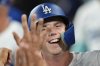 Los Angeles Dodgers' Will Smith is congratulated by teammates in the dugout after scoring on a wild pitch during the second inning of a baseball game against the Colorado Rockies, Tuesday, Sept. 9, 2025, in Los Angeles. (AP Photo/Mark J. Terrill)