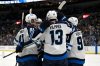 Winnipeg Jets center Gabriel Vilardi (13) is congratulated by teammates after scoring a goal against the St. Louis Blues during the third period of an NHL hockey game, Saturday, Feb. 22, 2025, in St. Louis. (AP Photo/Jeff Le)