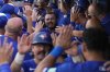 Blue Jays catcher Alejandro Kirk, top centre, celebrates with teammates in the dugout after hitting a grand slam against the Tampa Bay Rays during the first inning of a Major League Baseball game in Toronto on Sept. 28, 2025. THE CANADIAN PRESS/Chris Young