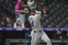 Miami Marlins'D'ane Myers follows the flight of his double to drive in two runs off Colorado Rockies starting pitcher Kyle Freeland in the sixth inning of a baseball game Tuesday, Sept. 16, 2025, in Denver. (AP Photo/David Zalubowski)