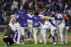 The New York Mets celebrate after defeating the San Diego Padres in a baseball game Tuesday, Sept. 16, 2025, in New York. (AP Photo/Adam Hunger)